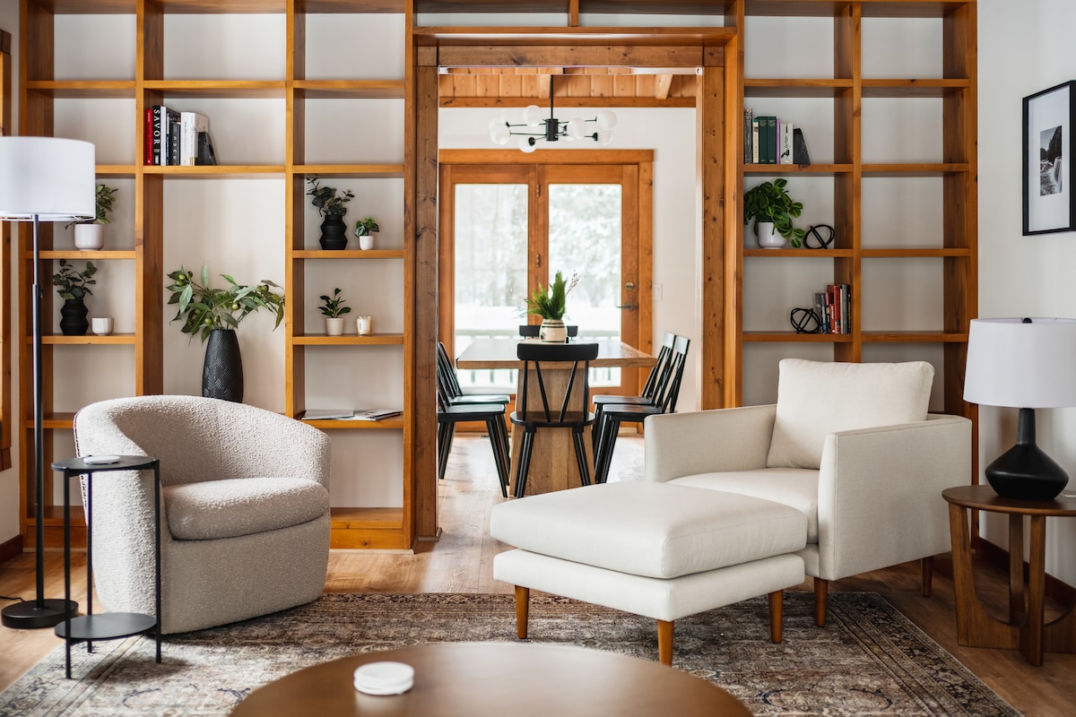 The light-filled living room and dining area at House in the Woods